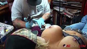 Hot tattooed girl plays with her tits